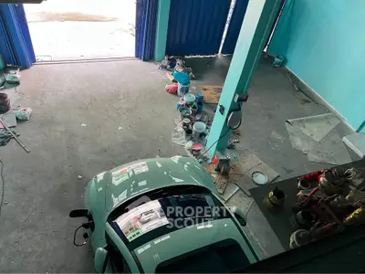 Spacious garage with car and storage space, ideal for automotive enthusiasts.