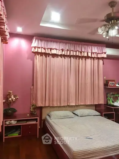 Charming pink-themed bedroom with cozy ambiance and stylish decor.
