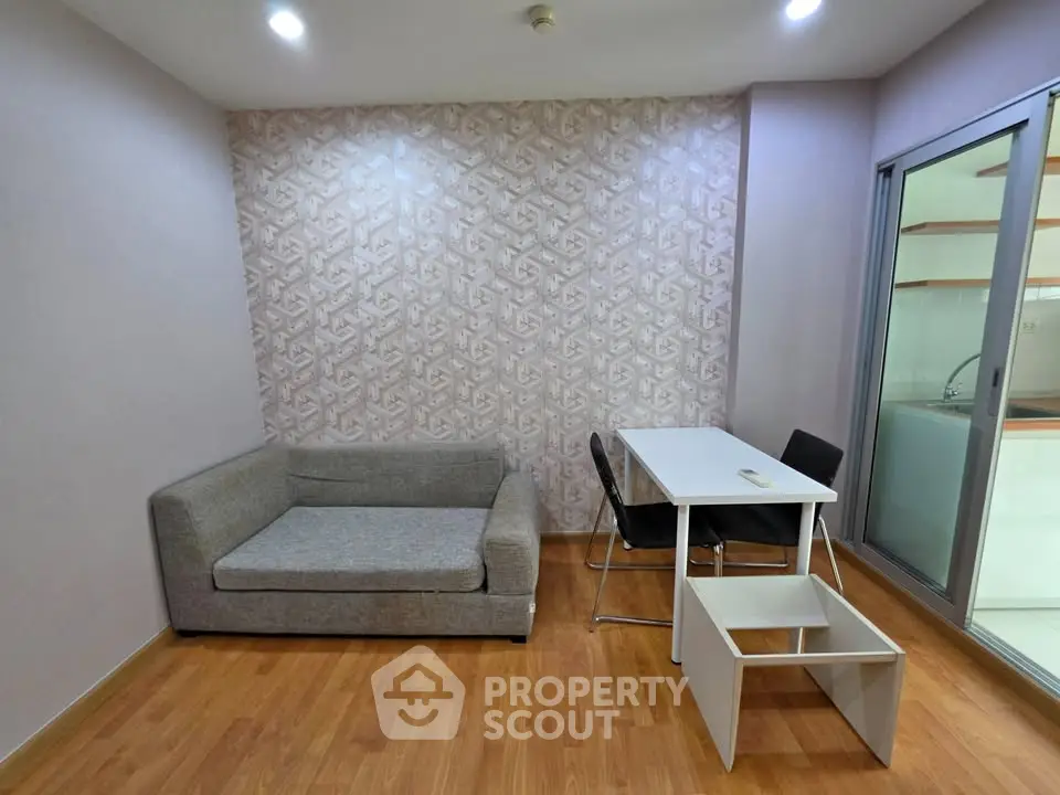 Modern living room with stylish furniture and wooden flooring, featuring a cozy sofa and dining area.