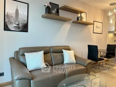 Stylish living room with modern decor, leather sofa, and elegant wall art in a cozy apartment.