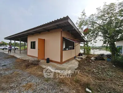 Charming rural property with potential, featuring a simple structure and spacious surroundings.