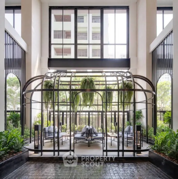 Luxurious modern building entrance with stylish seating and greenery