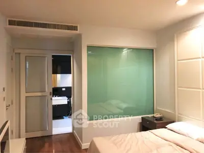 Modern bedroom with ensuite bathroom and stylish glass partition