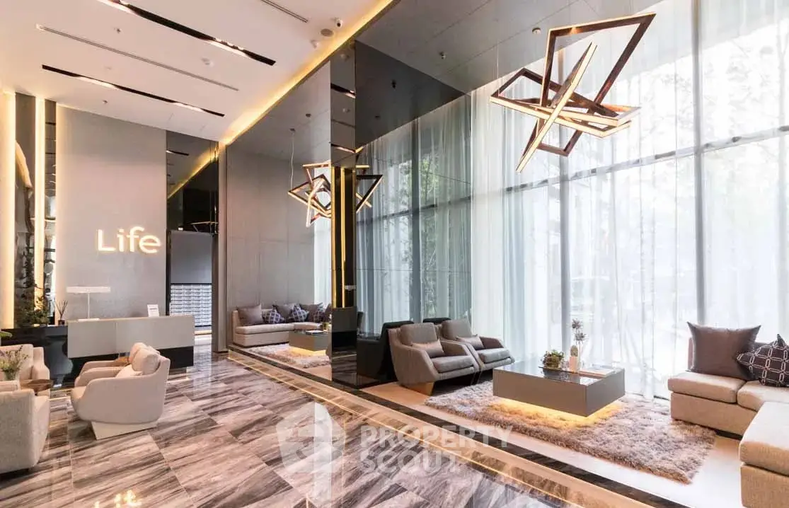 Luxurious modern lobby with high ceilings and stylish lighting in upscale building.