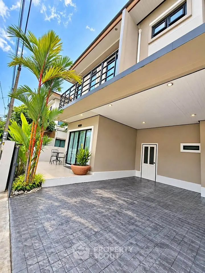 Modern two-story home with spacious driveway and lush greenery, perfect for family living.