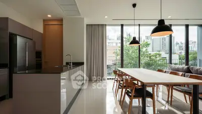 Modern open-plan kitchen and dining area with city view, sleek design and natural light.