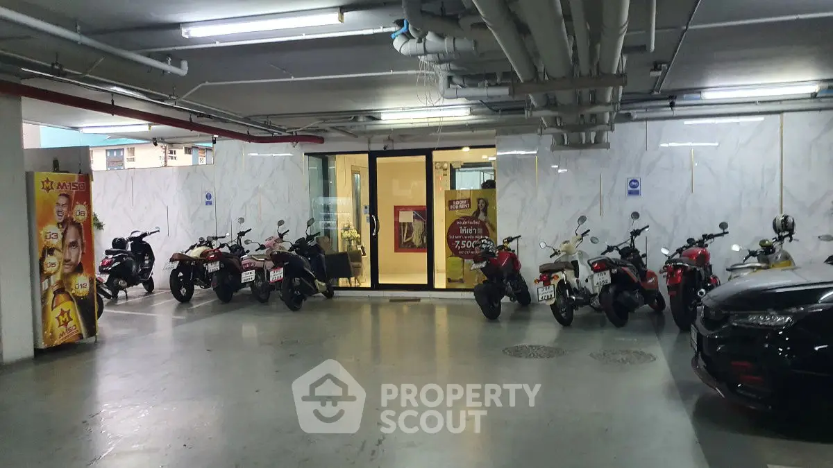 Modern parking area with motorcycles and sleek design in urban building.