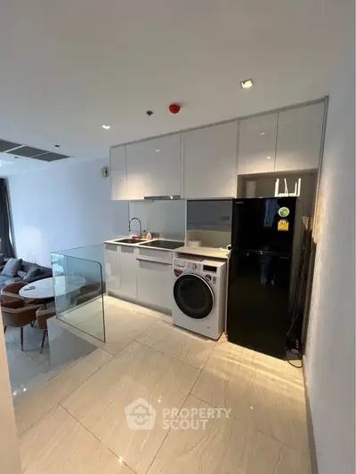 Modern kitchen with sleek appliances and open layout in stylish apartment