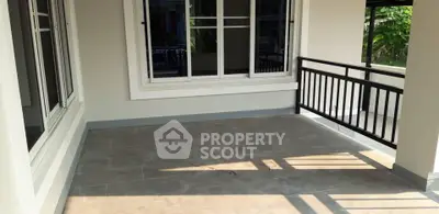 Spacious balcony with tiled flooring and modern railing, perfect for relaxation.