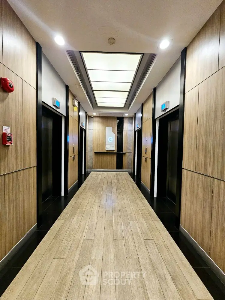 Modern elevator lobby with wood paneling and sleek lighting