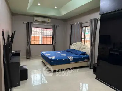 Spacious bedroom with modern decor and ample natural light