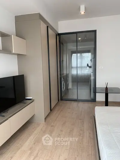 Modern studio apartment with sleek design and glass partition