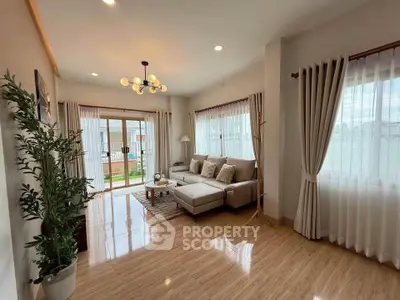 Spacious living room with modern decor and large windows for natural light.