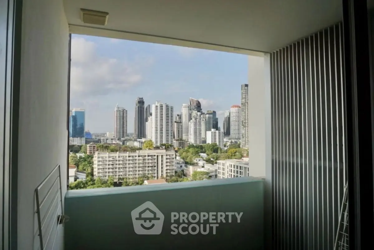 Stunning cityscape view from a modern balcony in a high-rise apartment.