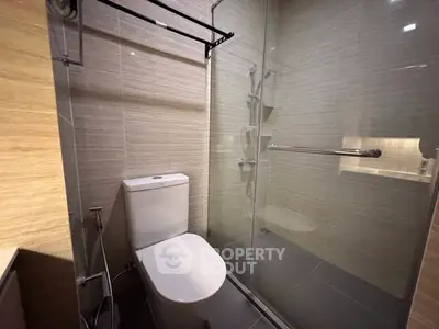 Modern bathroom with glass shower and sleek toilet design