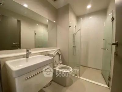 Modern bathroom with sleek fixtures and glass shower enclosure
