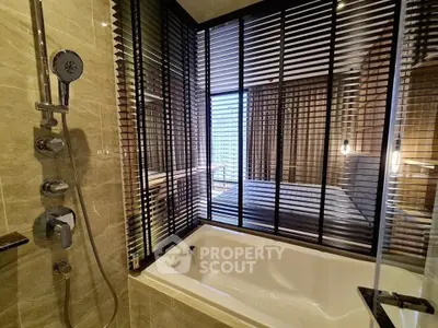 Luxurious bathroom with modern bathtub and sleek design in upscale apartment.