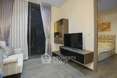 Modern living room with sleek TV unit and cozy bedroom view