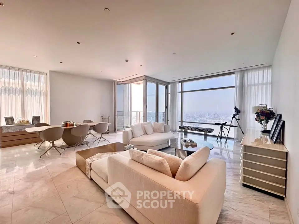 Luxurious living room with panoramic city view, elegant furniture, and modern decor in high-rise apartment.