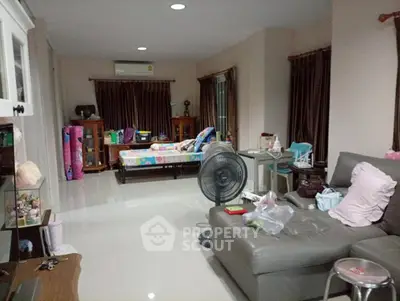 Spacious living room with modern furniture and ample natural light.