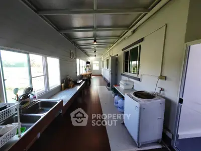 Spacious corridor with large windows and utility area in modern home