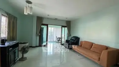 Spacious living room with modern furniture and large windows for natural light.