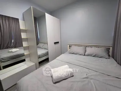 Cozy bedroom with modern furniture and soft lighting, perfect for relaxation.