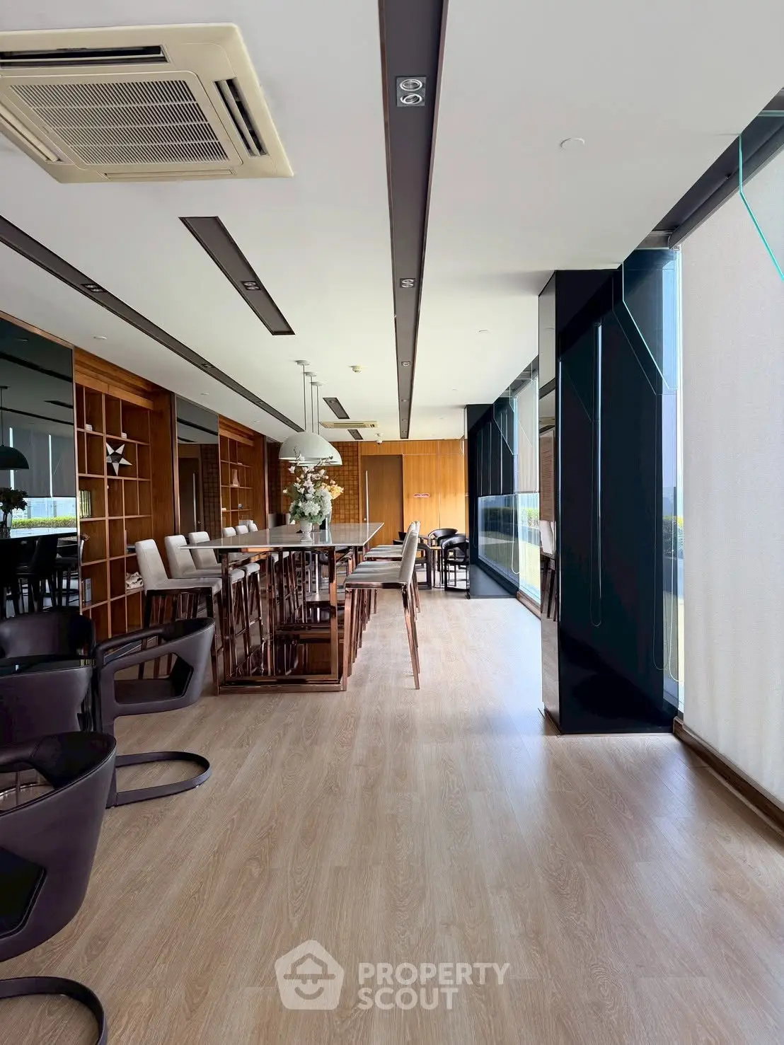 Luxurious modern living room with floor-to-ceiling windows and elegant wooden flooring.
