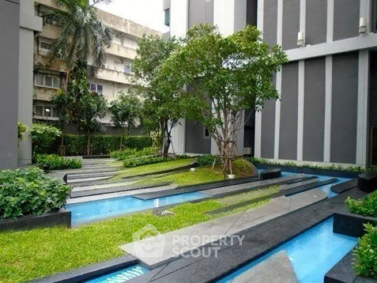 Modern building exterior with landscaped garden and water features