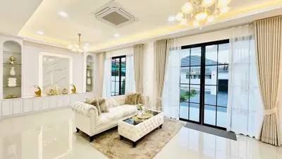 Luxurious living room with elegant decor and large windows offering natural light.