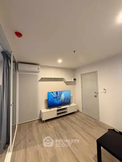 Modern living room with sleek TV setup and stylish flooring