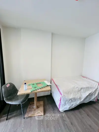 Distorted image of a bedroom with pillows and bedspread.