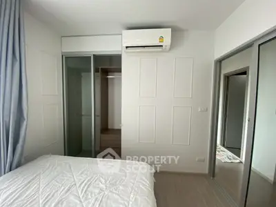 Modern bedroom with air conditioning and sliding closet doors