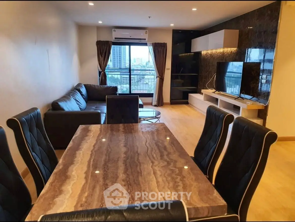 Spacious modern living room with elegant dining area and city view