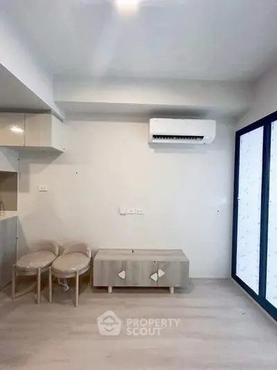 Modern minimalist living room with air conditioning and sleek furniture