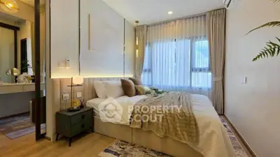 Elegant bedroom with cozy decor and large window, perfect for relaxation and comfort.