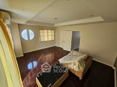 Spacious living room with hardwood floors and natural light