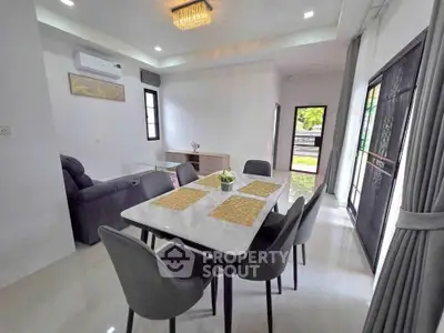 Modern dining area with sleek furniture and natural light in a stylish home interior.