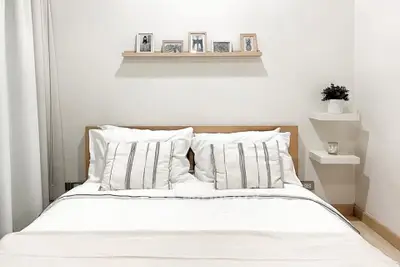 Cozy minimalist bedroom with stylish decor and comfortable bedding