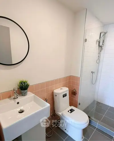 Modern bathroom with sleek shower and stylish sink in a contemporary home.