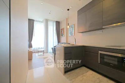 Modern open-plan kitchen and living room with sleek design and natural light