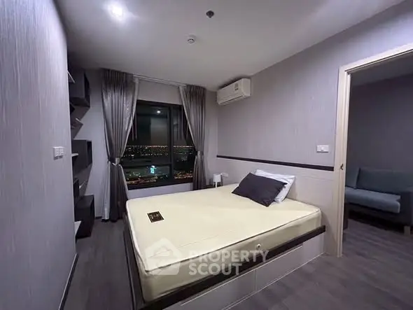 Modern bedroom with city view, featuring sleek design and ambient lighting for a cozy atmosphere.