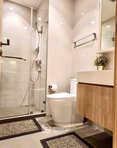 Modern bathroom with glass shower and wooden vanity