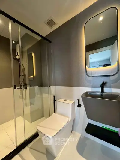 Modern bathroom with sleek fixtures and glass shower enclosure