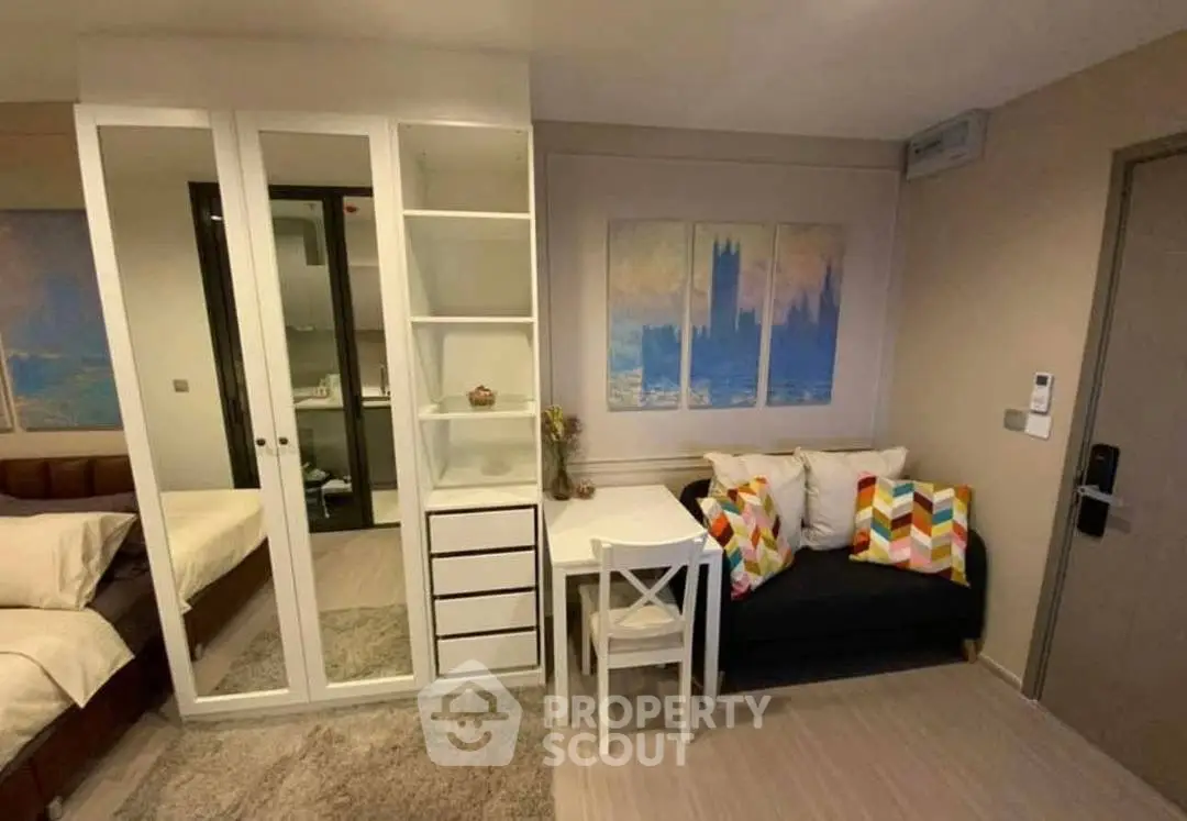 Cozy studio apartment with modern decor and compact living space.