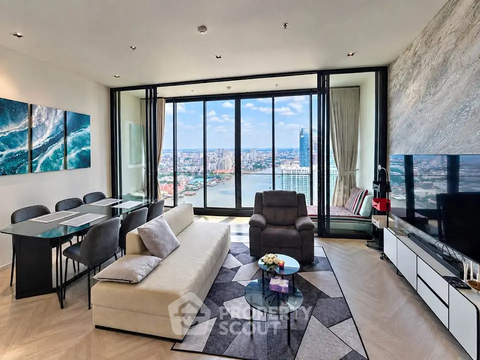 Luxurious living room with stunning river view, modern furniture, and elegant decor in high-rise apartment.