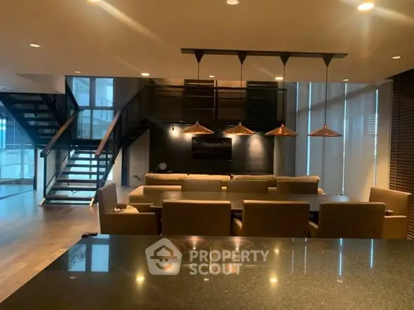 Luxurious modern living room with elegant lighting and open staircase, perfect for entertaining.