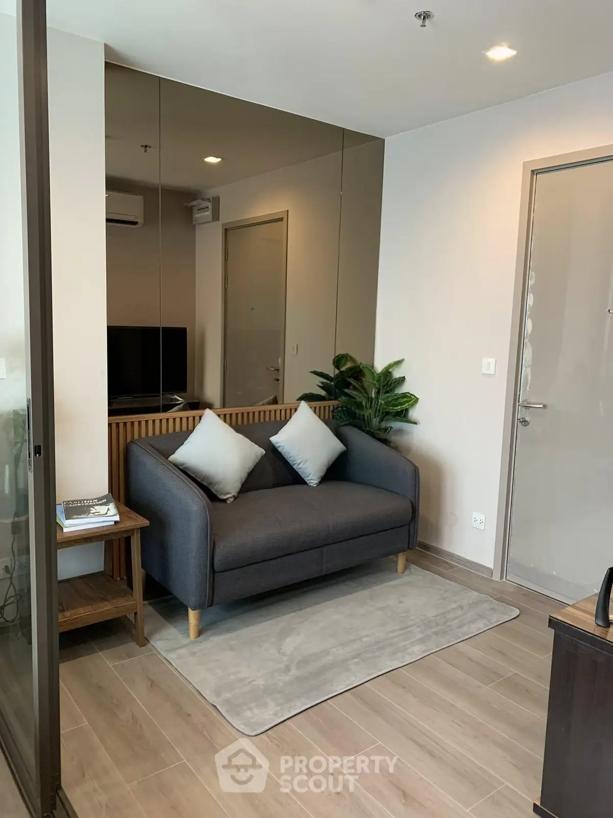 Modern living room with stylish sofa and decor in a cozy apartment setting.