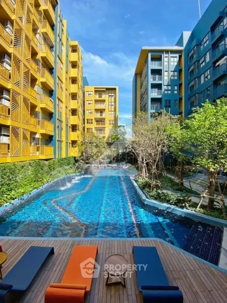 Stunning modern apartment complex with vibrant colors and inviting pool area.