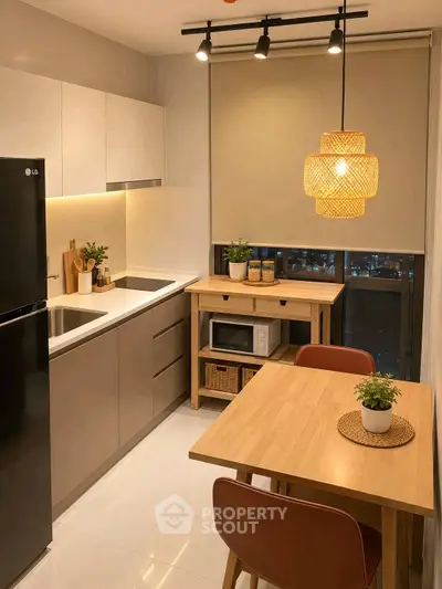 Modern kitchen with sleek cabinets, dining table, and city view, perfect for urban living.